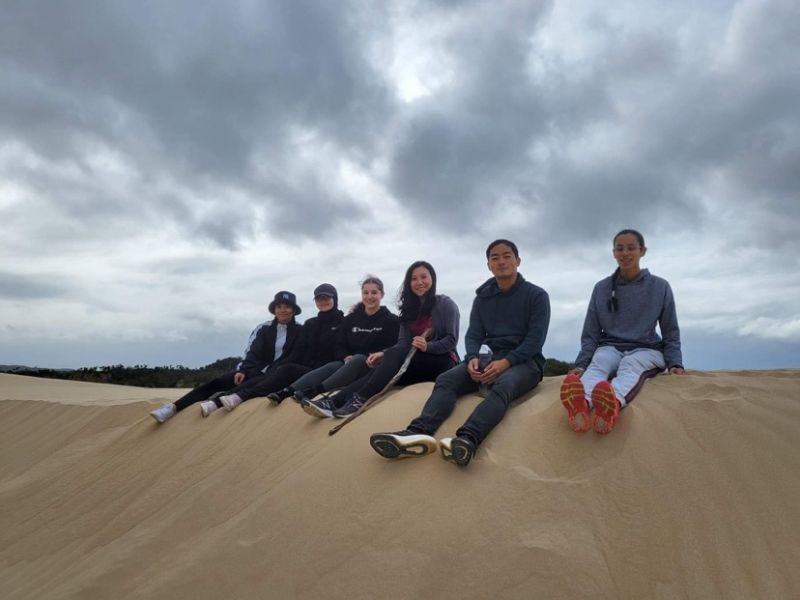 Final year Bachelor of Oral Health and Dentistry students pose for a photo in the sand dunes at Wilsons Promontory National Park