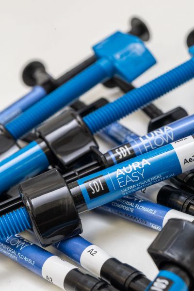 A close-up of a pile of syringes filled with composite material provided by industry partner SDI for testing