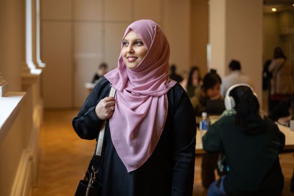 Dr Nadia Kaunein in the State Library Victoria, looking towards the left in a candid shot