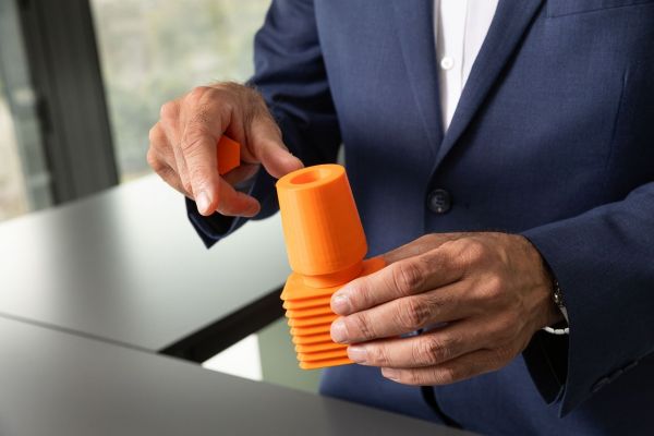 Associate Professor Roy Judge stands with a prototype of the Rectangular Block Implant in a laboratory space in the Aikenhead Centre for Medical Discovery. Credit: Peter Casamento