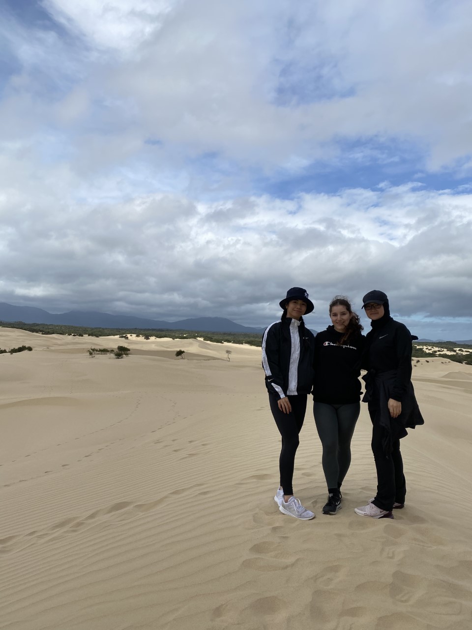 Final year Bachelor of Oral Health and Dentistry students pose for a photo in the sand dunes at Wilsons Promontory National Park