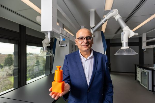 Associate Professor Roy Judge stands with a prototype of the Rectangular Block Implant in a laboratory space in the Aikenhead Centre for Medical Discovery. Credit: Peter Casamento